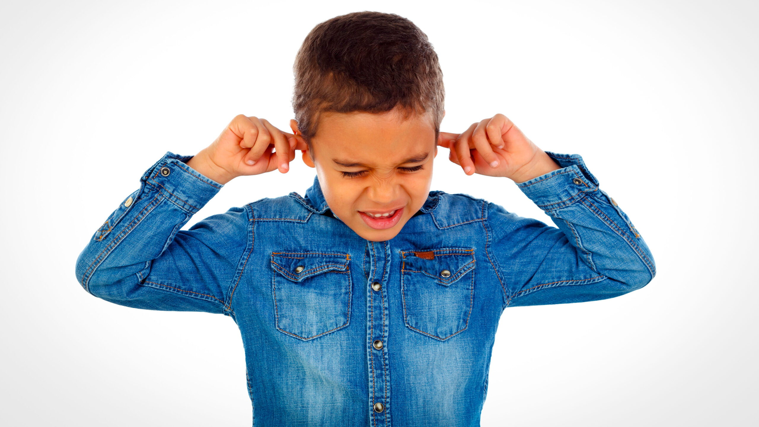 little boy covering his ears