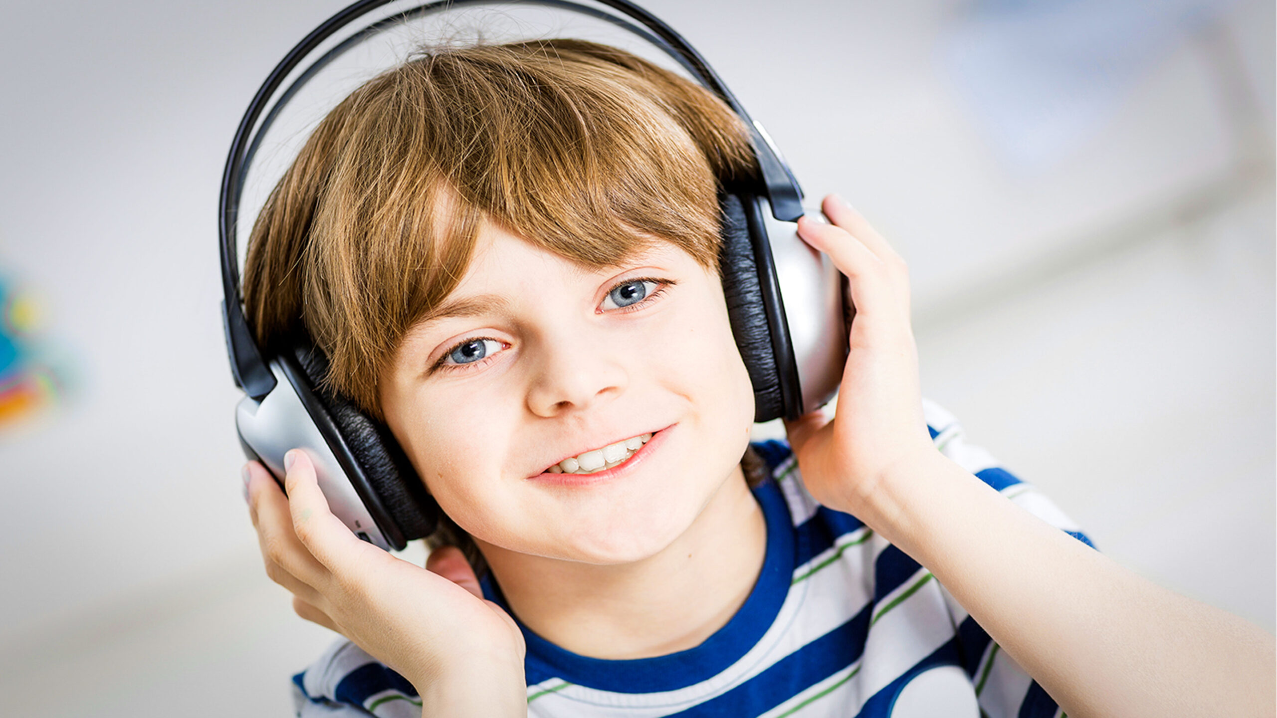 little boy wearing noise canceling headphones