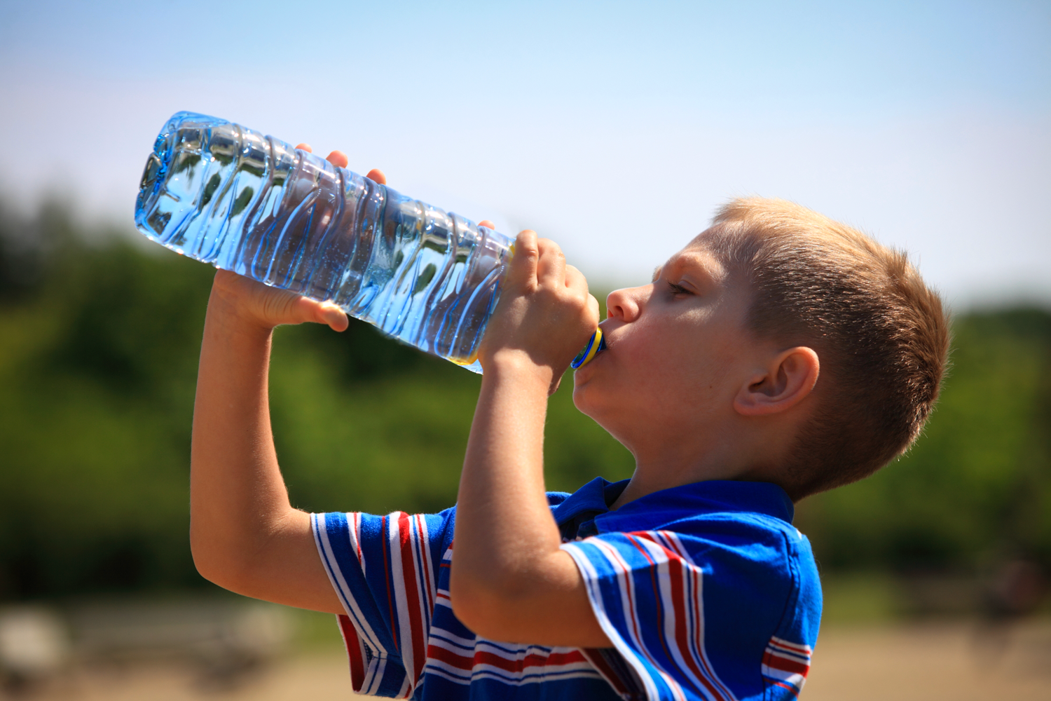 interoception skills- a little boy feeling thirsty and drinking water.