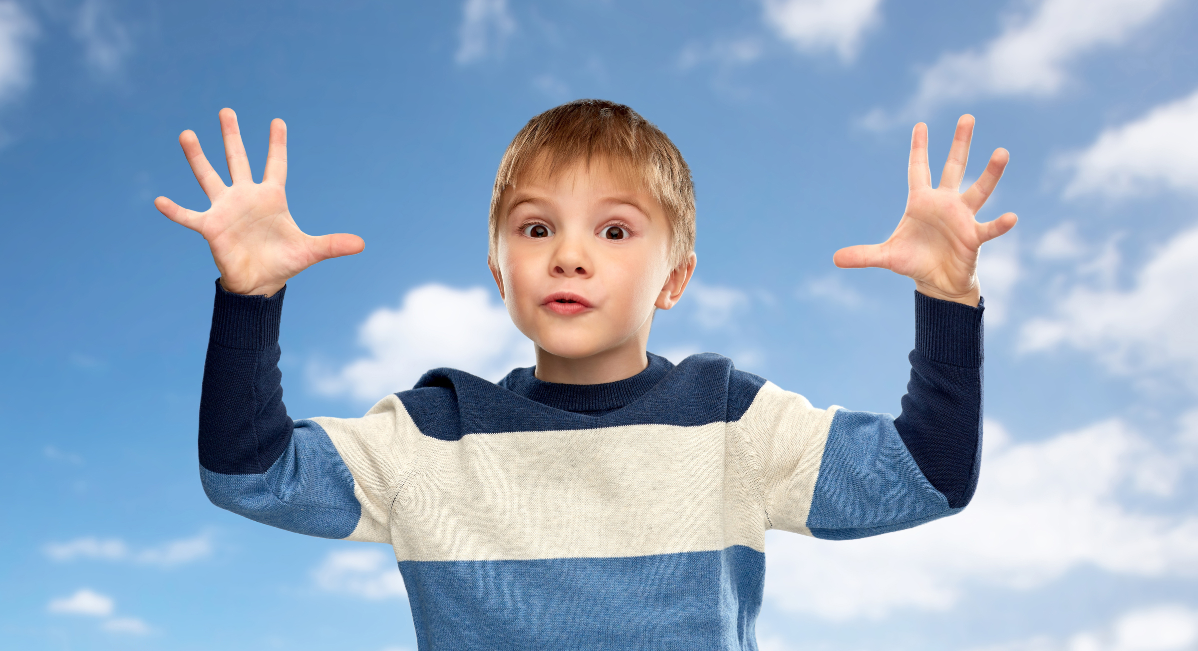 A little boy hand flapping, a common repetitive behavior in children with Autism